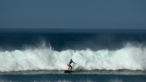 Young-woman-at-practice-surfing-a-wave