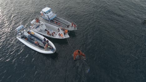 Seamen-Laying-Inflatable-Boat-Into-The-Sea-During-Their-Nautical-Training-In-Patagonian-Sea---Aerial-Shot