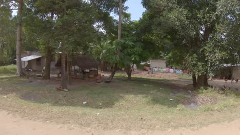 Poor-temporary-houses-in-African-village,-drive-through-Zanzibar,-Tanzania