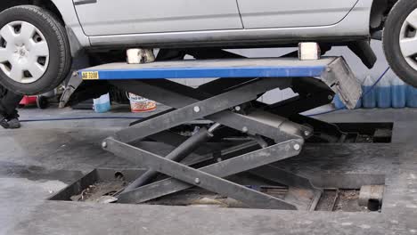 Car-is-raised-by-scissor-jack-car-hydraulic-industrial-lift