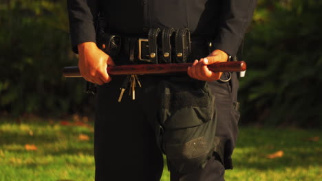 Policeman-Holding-Baton-at-Black-Lives-Matter-Protest,-Static-Front-View,-Close-up-on-Hands