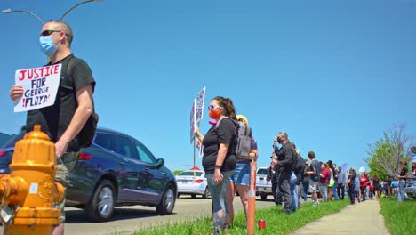 Janesville-Wisconsin-USA-Peaceful-protesters-holding-signs-on-the-side-of-the-road-showing-solidarity-with-the-black-community-black-lives-matter-protests-in-America