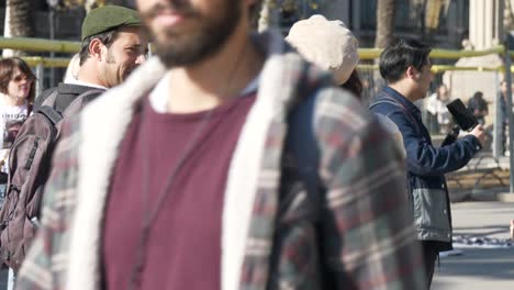 Male-vintage-camera-photographer-in-Barcelona-city-chatting-to-female-tourist