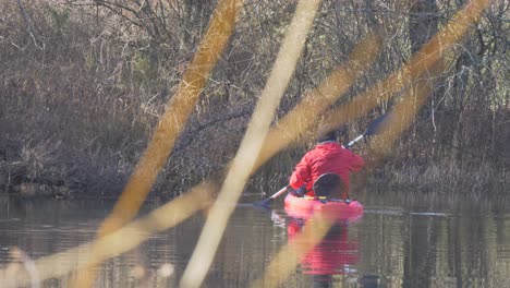 man-kayaking-in-pond-turning-slow-motion-hand-held