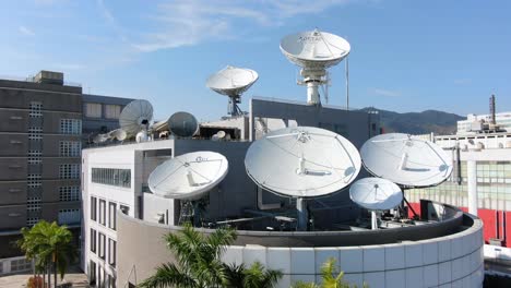 Cluster-of-Satellite-broadcast-Dishes-on-Asia-Pacific-Telecommunications-building-in-Hong-Kong,-Aerial-view