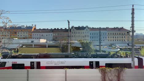 Various-scenes-of-commuter-trains-passing-in-front-of-buildings-in-the-city-of-Vienna,-Austria