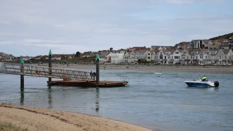 Men-waiting-boarding-fishing-tourist-boat-from-Conwy-steel-jetty-waterfront