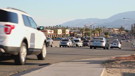 Interstate-10-highway-traffic-in-arid-mountain-valley,-Indio,-California,-USA