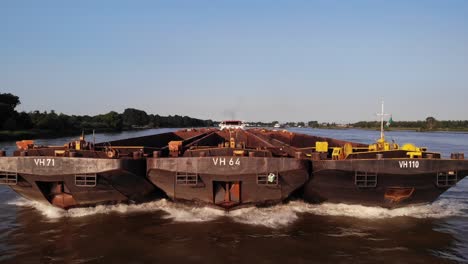 Aerial-View-Of-Forward-Bow-Of-Veerhaven-Pusher-Boat-Transporting-Three-Barges-Along-Oude-Mass