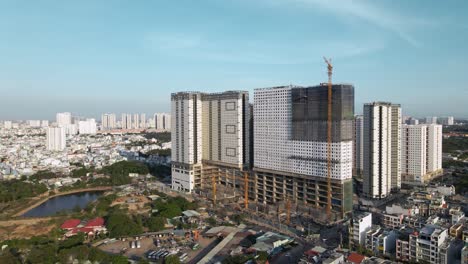 Drone-flying-sideways-shows-a-building-under-construction-with-clear-sky-line