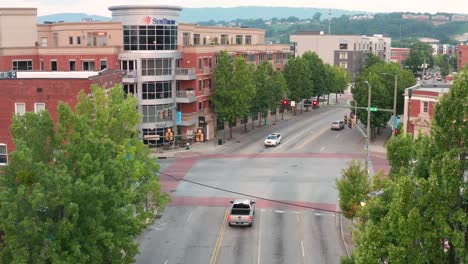 Aerial-street-view-of-Sun-Trust-Bank-and-Trust-building-along-busy-street-in-town,-USA