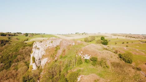 Clockwise-aerial-drone-shot-of-Thor's-Cave,-Ashbourne,-Peak-District