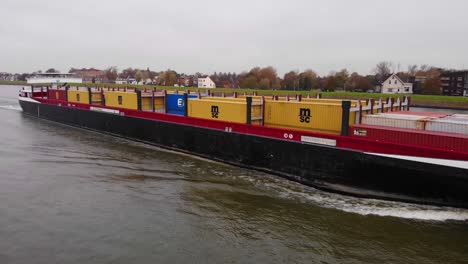 Aerial-Starboard-View-Along-Bolero-Cargo-Ship-Navigating-Along-River-Noord-Near-Hendrik-Ido-Ambacht