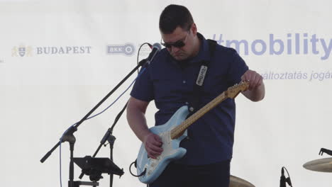 Lead-guitarist-tunes-instrument-on-stage-before-performance