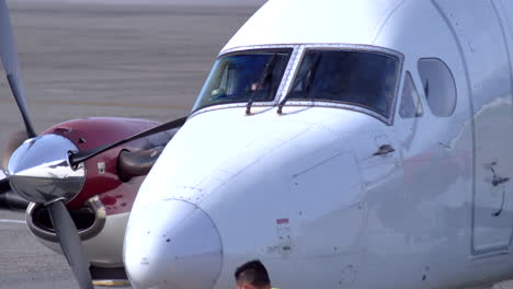 Exterior-Shot-of-Cockpit-of-a-Beech-1900-Turboprop-with-Ground-Crew