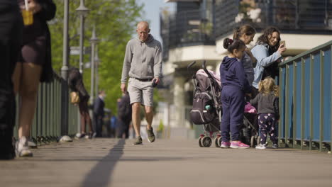 Elder-man-walking-with-confidence-in-urban-area-of-London-city,-slow-motion-view