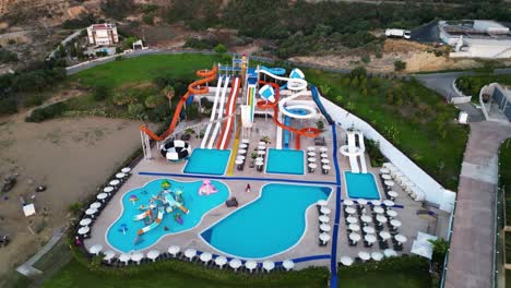 Aerial-drone-forward-moving-shot-over-an-empty-water-park-in-Nicosia,-Cyprus-at-daytime