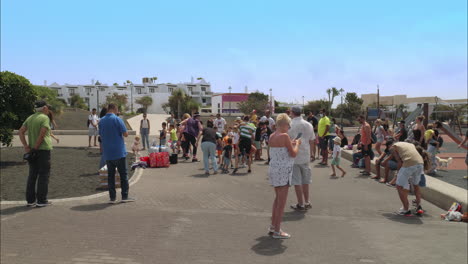 Children-and-parents-dancing-and-exercising-in-local-outdoor-play-area-during-summertime-on-a-bright-sunny-day