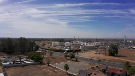 Wide-push-in-aerial-shot-of-an-oil-refinery-in-the-farmland-of-Central-California