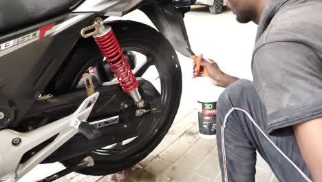 Detailer-Spraying-On-Around-Back-Wheel-Of-Honda-CB150F