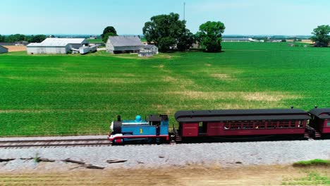 Thomas-the-Train-Steam-Locomotive-in-Amish-Countryside-on-a-Sunny-Summer-Day-as-seen-by-a-Drone