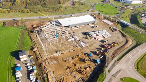 Hyperlapse-aerial-view-over-construction-site-with-crane,-excavator,-bulldozer-and-truck