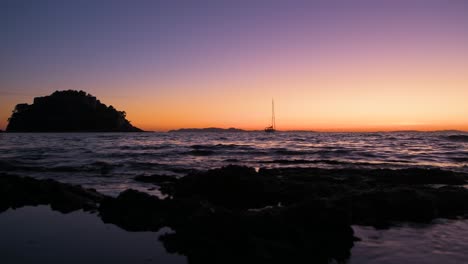 "Fort-de-Brégançon"-castle,-holiday-residence-of-French-presidents-at-dusk-with-sailboat-anchored-in-the-bay