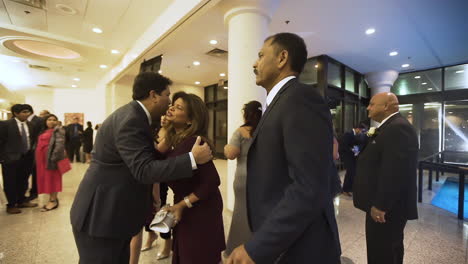 Family-members-shaking-hands-at-a-wedding-reception