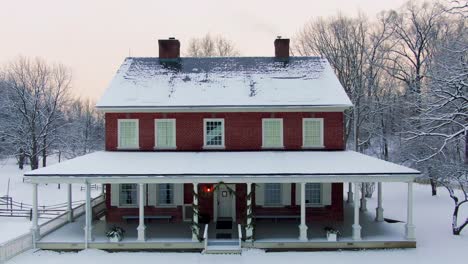 Descending-and-revealing-an-aerial-view-of-a-Georgian-mansion-in-Lancaster,-Pennsylvania,-beautiful-historic-house-with-red-brick-facade,-Rock-Ford-Plantation-in-Winter,-travel-concept,-historic-site