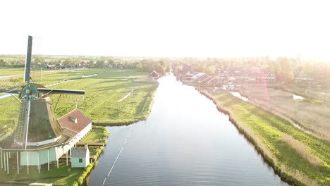 Aerial-Drone-Shot:-Flying-past-typical-dutch-windmills,-during-sunset