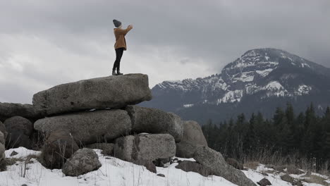 A-girl-takes-pictures-of-the-snowy-mountains-around-her