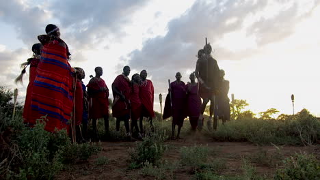 A-Maasai-tribe-engage-in-ritual-dances-at-sunset-on-tribal-lands-near-Amboseli-National-park-during-late-summer-under-cloudy-skies