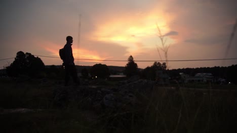 Silhouette-of-a-guy-looking-at-sunset-landscape-in-Kaapschehoop,-South-Africa