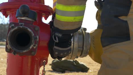 Firefighter-attaches-a-fire-hose-to-a-fire-hydrant-for-firefighting