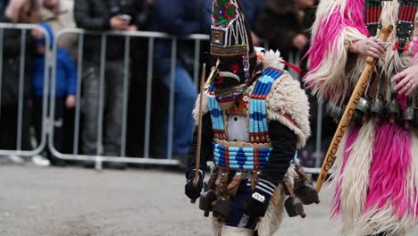 Bulgarian-kuker-child-wearing-a-wooden-sword-in-costume-with-beads-and-heavy-bells-on-the-waist