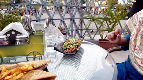 A-Server-or-Waiter-Serves-Pan-Fried-Continental-Cottage-Cheese-Fritters-at-a-Cafe-Table-to-Guests