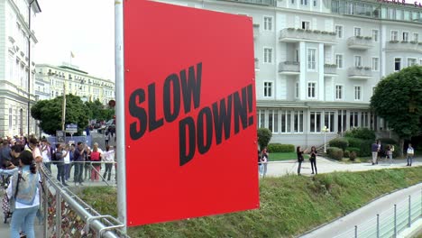 The-bridge-Makartsteg-or-the-Love-locks-bridge-in-Salzburg-with-a-sign-that-says-"slow-down