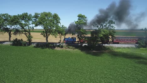 Aerial-View-of-a-Thomas-the-Tank-Engine-with-Passenger-Cars-Puffing-along-Amish-Countryside