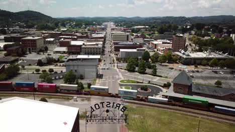 Aerial-pullout-from-Bristol-Tennessee,-Virginia-skyline-to-reveal-state-line-sign