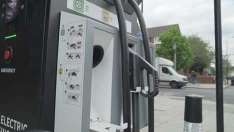 This-is-a-close-up-shot-of-a-black-motorist-using-a-rapid-car-charging-point-in-London-on-a-busy-high-street