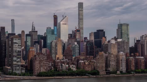 Time-lapse-of-clouds-over-the-skyscrapers-at-Manhattan-Midtown-East,-FDR-Drive-and-East-River-at-Daylight,-New-York-City-at-June-2019