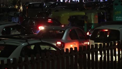 A-man-helping-to-move-cars-during-slowly-moving-traffic-in-evening-rush-hours-in-New-Delhi