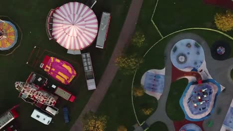 VERTICAL-aerial-flight-birds-eye-above-circus-tents-in-green-field