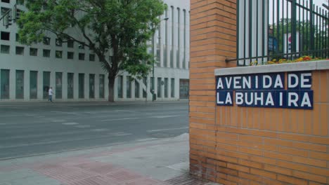 Slow-Motion,-Man-walks-past-corner-of-Avenida-de-La-Buhaira-in-Seville,-Spain