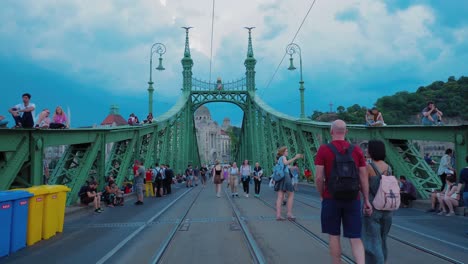 People-walking-through-Liberty-brige-in-szabihid-festival