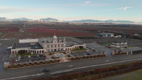 Drone-4K-Footage-front-fascade-of-Hindu-temple-with-beautiful-and-elaborate-sculpture-and-symmetrical-architecture-showing-the-entrance-and-highway-mountains-blue-sky-blueberry-fields