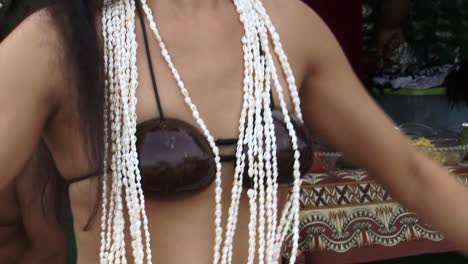 Close-up-of-a-Polynesian-young-girl-dancing-and-opening-to-wide-frame-of-3-dancers