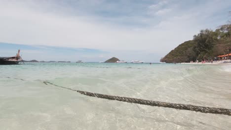 Boat-moored-on-clear-sea-waters-of-Coral-Island,-Thailand