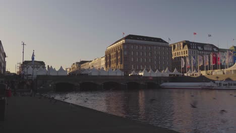 People-enjoying-the-weather-at-a-Christmas-market-at-Binnenalster-in-Hamburg,-Germany,-in-Dec-2019