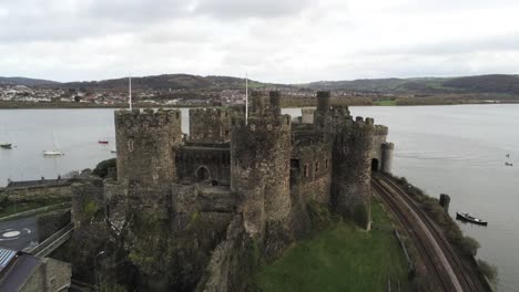 Historical-medieval-Conwy-castle-landmark-aerial-view-rising-pull-back